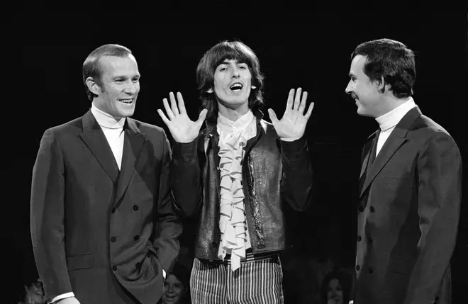 George Harrison launches The Beatles&squot; "White Album" on The Smothers Brothers Comedy Hour in November 1968. Tommy Smothers is on the far left.