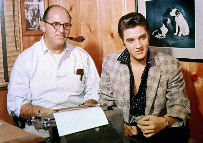 Elvis Presley with his manager,Colonel Tom Parker, signing a record contract with RCA Victor, October 1955.