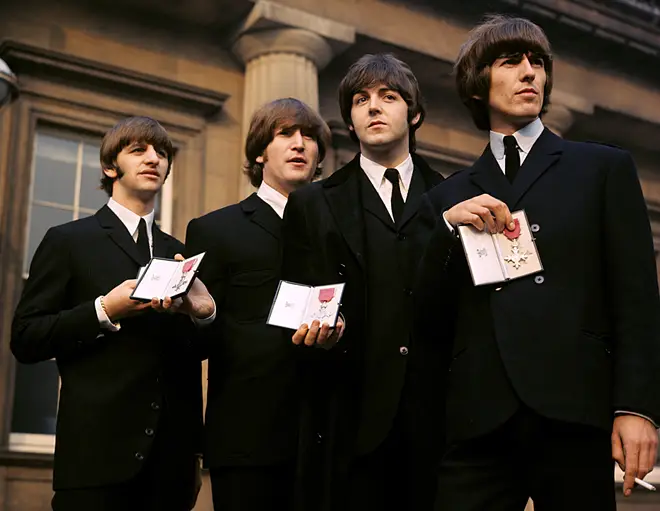 The Beatles outside Buckingham Palace, London, after receiving their MBEs