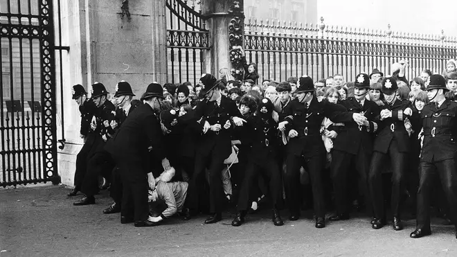 Fans outside Buckinham Palace as The Beatles receive their MBEs, 26 October 1965