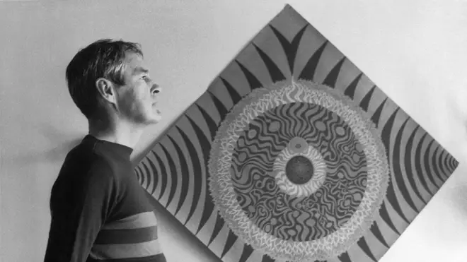 Psychologist and LSD proponent Timonthy Leary standing next to a mandala in 1966.