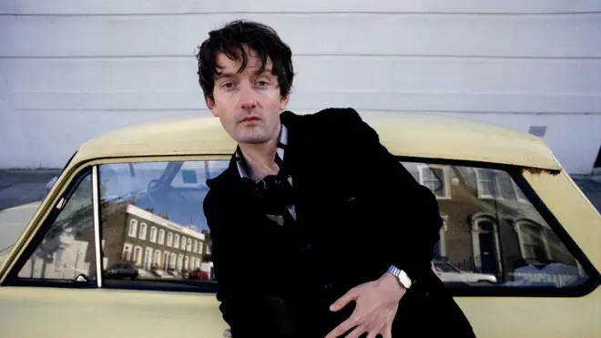 Pulp singer Jarvis Cocker, portrait, standing by a Hillman Imp car, London , United Kingdom, 1991.