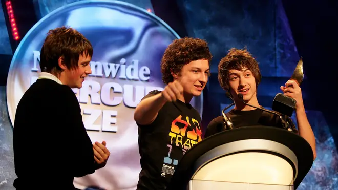 Jamie Cook, Matt Helders and Alex Turner accept the Nationwide Mercury Prize winners award