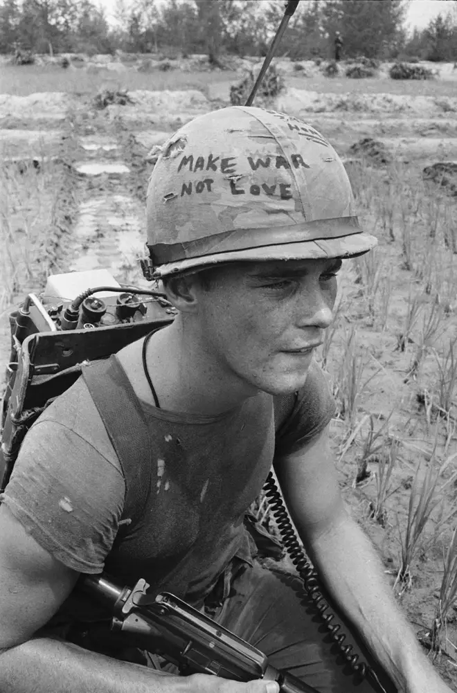 Da Nang, South Vietnam: Marine Cpl. Michael Wynn, 20, of Columbus, Ohio, seems to be trying to get a message across with a takeoff of the hippie slogan "make war not love" written on his helmet here.