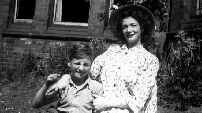 Nine year old John Lennon poses for a portrait with his mother Julia