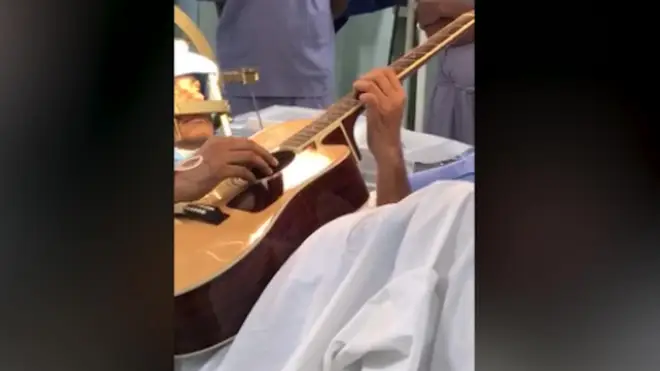 Musician Abhishek Prasad plays guitar as he undergoes brain surgery