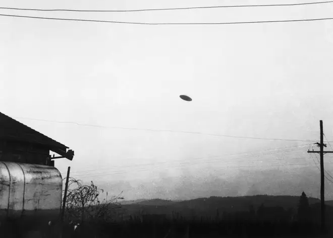 A picture of a flying saucer photographed by farmer Paul Trent shown flying over his farm, November 1950