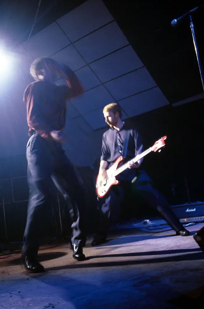 Ian Curtis and Peter Hook of Joy Division performing live in October 1979