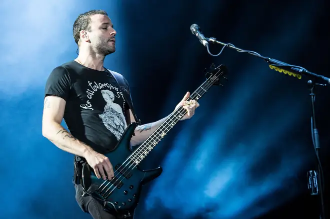 Chris Wolstenholme onstage with Muse at Austin City Limits festival in 2013